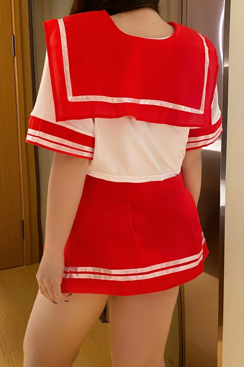 Back view of student uniform costume with red pleated mini skirt and sailor collar top.