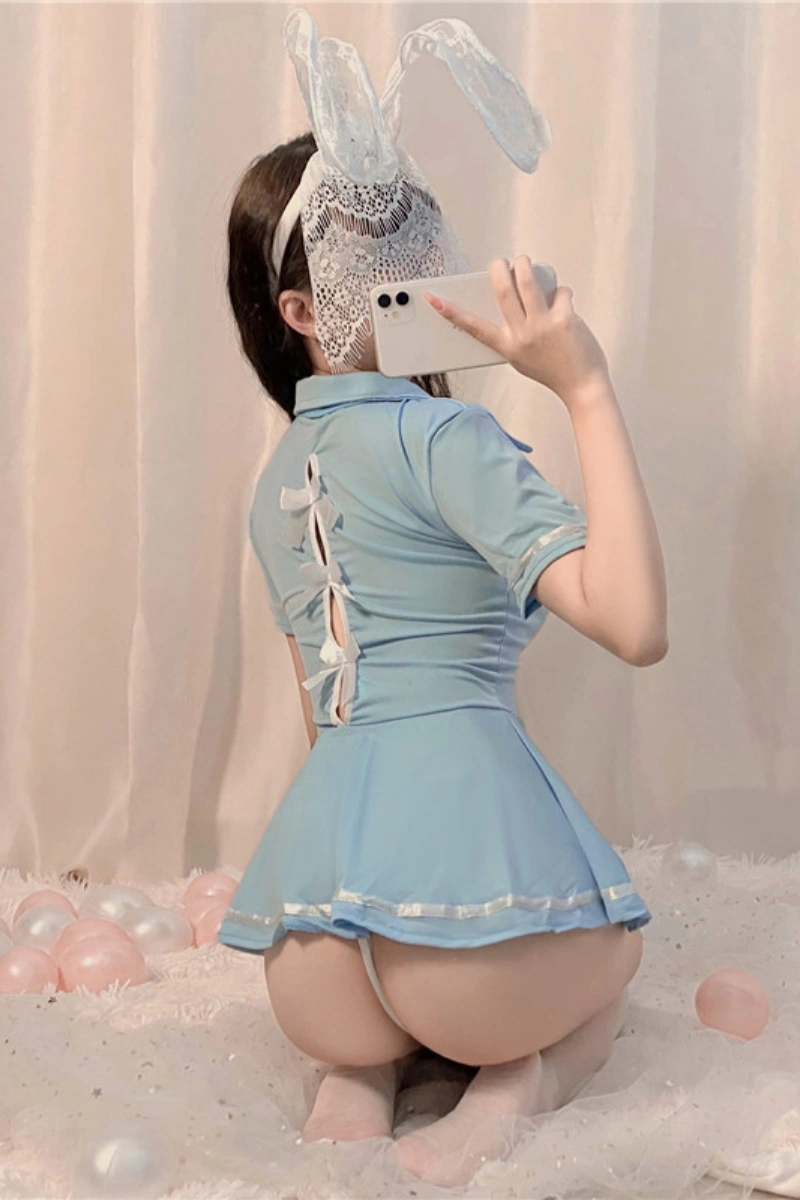 Back view of wholesale mini bunny lingerie dress in light blue, featuring bow-tied open back and mini skirt.
