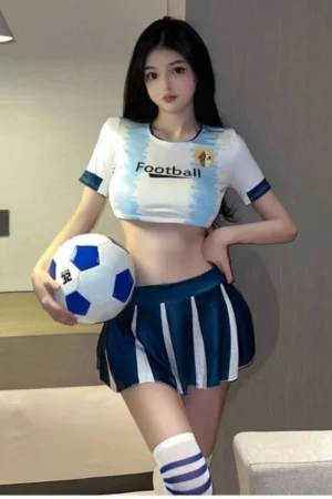 Model wearing wholesale student cosplay costume featuring a white crop top with “Football” print and blue pleated skirt.