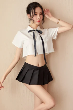 Sexy wholesale white JK lingerie outfit with a short white shirt, black ribbon tie, and pleated black skirt.