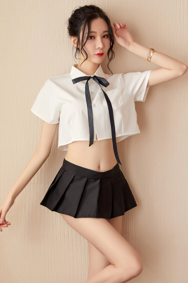 Sexy wholesale white JK lingerie outfit with a short white shirt, black ribbon tie, and pleated black skirt.