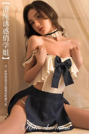 A model wearing b2b JK sailor uniform lingerie in ivory and navy with a large bow and ruffle detailing, ideal for wholesale buyers.