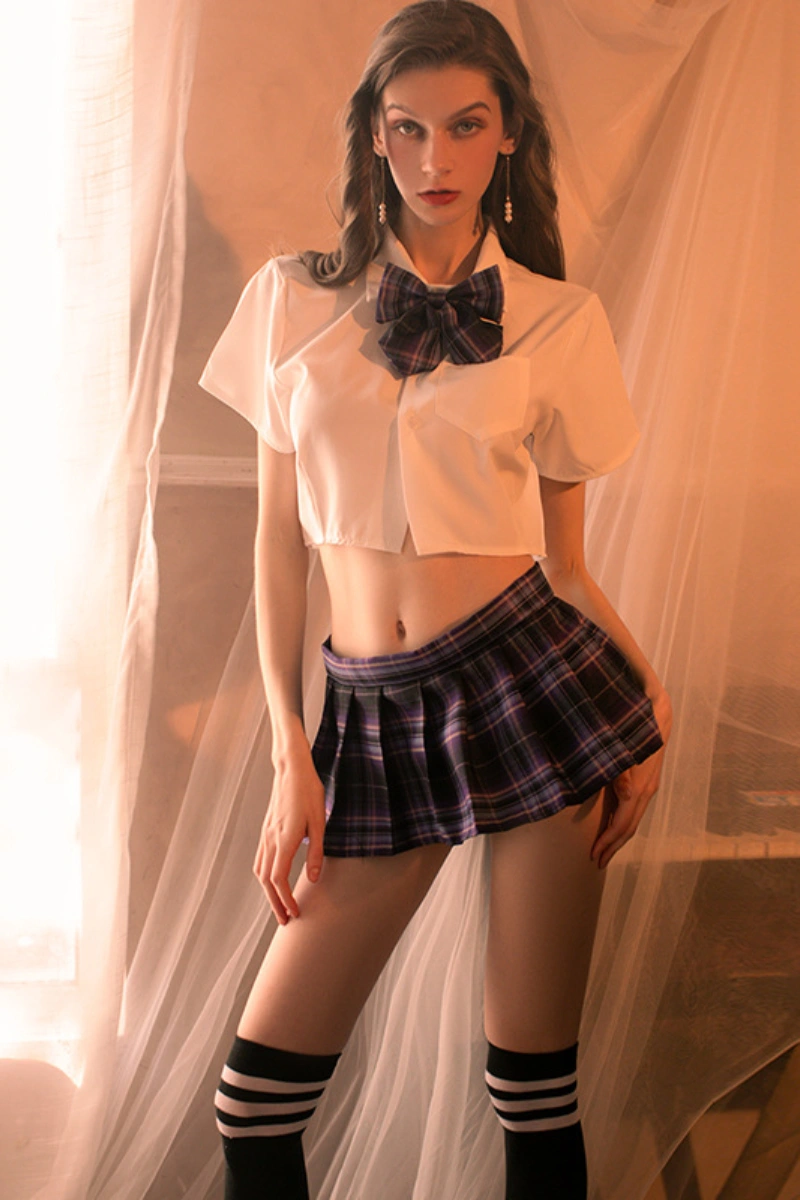 Model wearing b2b Japanese JK cosplay lingerie with dark plaid mini skirt and bow tie.