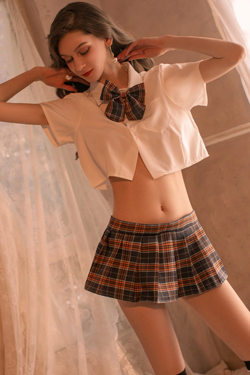 Female model in b2b Japanese JK cosplay lingerie with orange plaid skirt and matching bow tie.