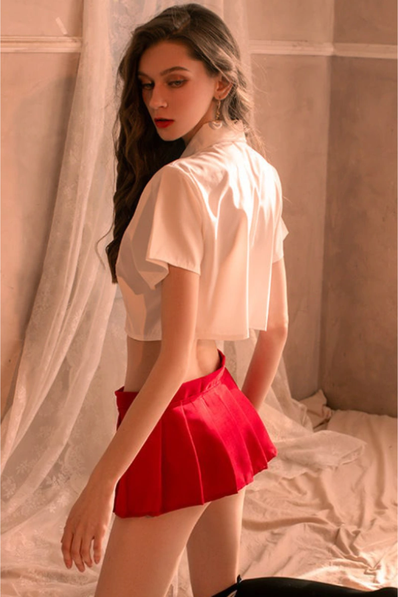 Back view of model wearing b2b Japanese JK cosplay lingerie with red pleated skirt.