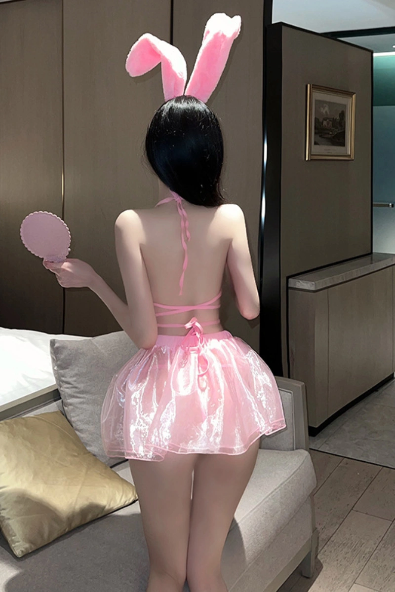 Back view of b2b velvet bunny lingerie in pink, featuring halter straps, fluffy bunny ears, and layered skirt.
