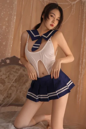 Sexy wholesale JK mini skirt costume with a sleeveless white bodice and pleated navy skirt, styled with a sailor collar.