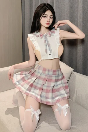 Model kneeling in wholesale JK sailor uniform lingerie featuring pink plaid skirt and bow tie design.