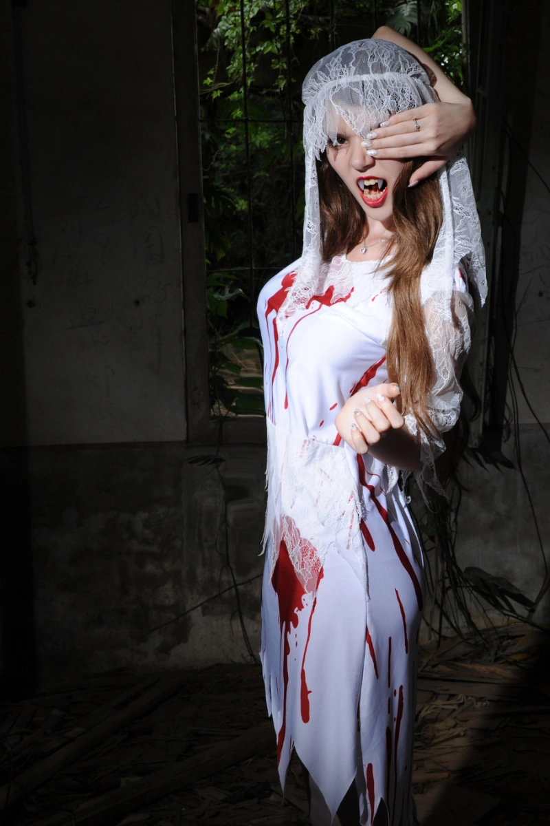 Female model dressed in Bloody Bride Cosplay Costume with blood-stained gown and lace headpiece