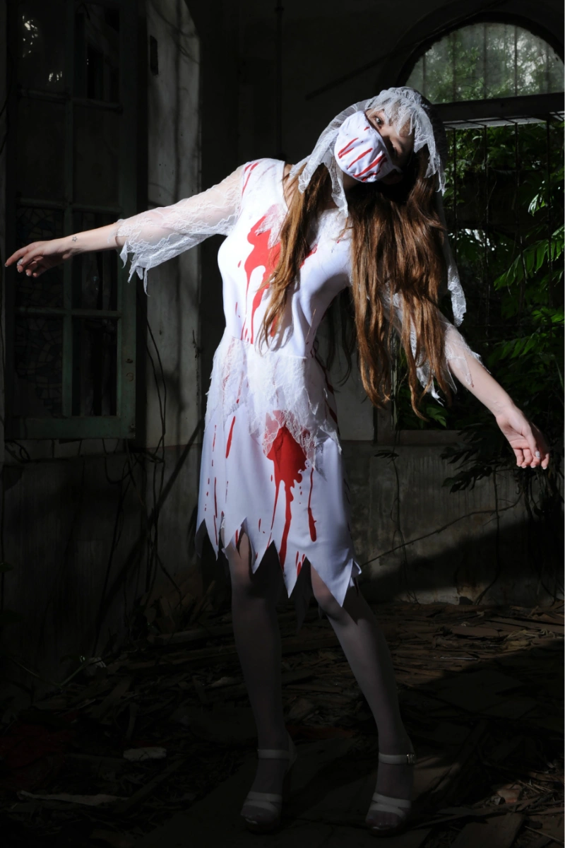 Full-body shot of model in Bloody Bride Cosplay Costume with lace veil and horror-inspired blood splashes