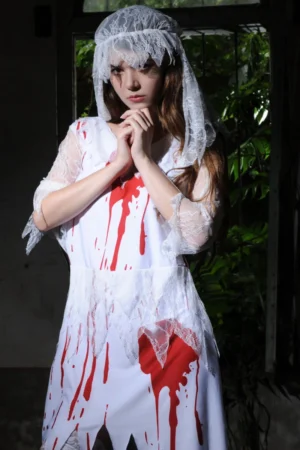 Model posing in Bloody Bride Cosplay Costume showing lace details and red blood effects on dress