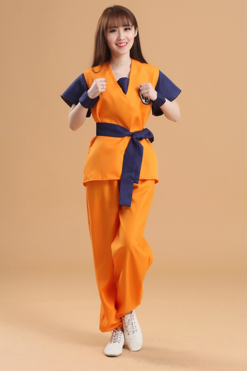 Female model dressed in Dragon Ball Anime Cosplay Costume striking a fighting pose with orange pants and navy belt