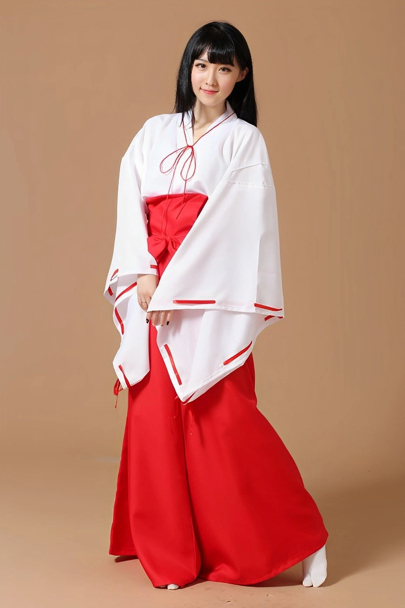 A model wearing Japanese Shrine Maiden Costume featuring a white kimono top with red details and wide red hakama pants.