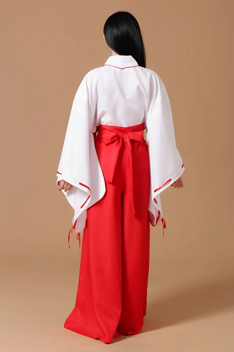 Back view of Japanese Shrine Maiden Costume showing a red obi tied at the waist with a white kimono and red pants.