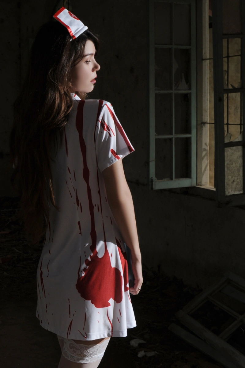 Back view of a Zombie Nurse Outfit showing blood splatter pattern and nurse hat.