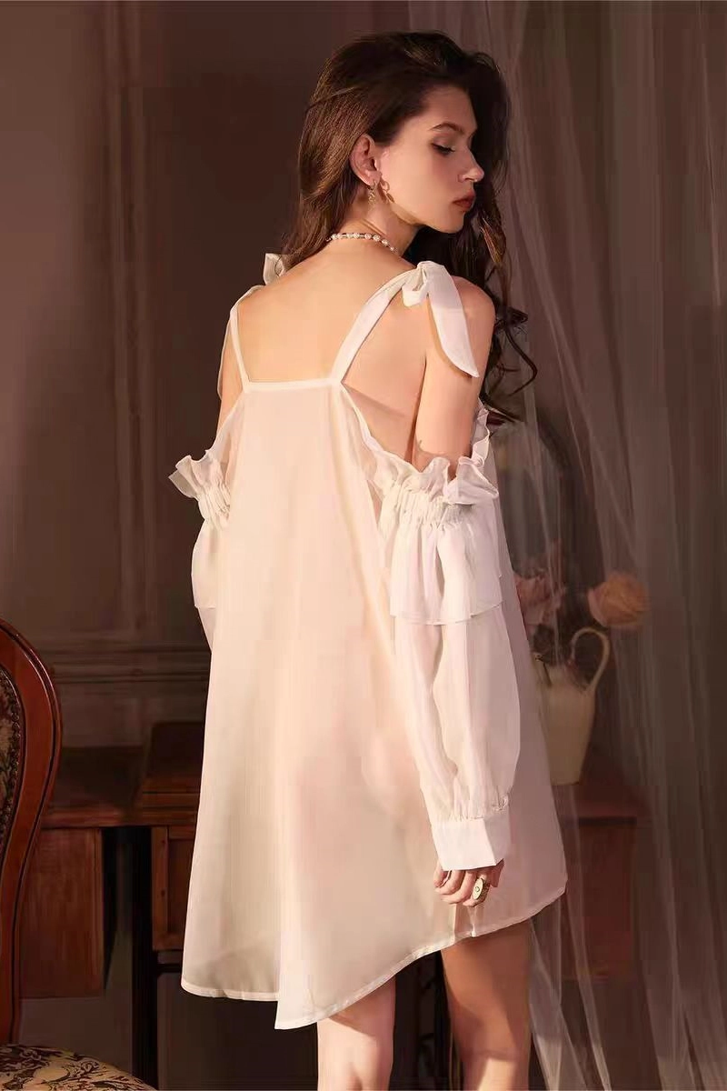 Alt: Back side of model showcasing ivory b2b lace silky pajamas with tied shoulder straps