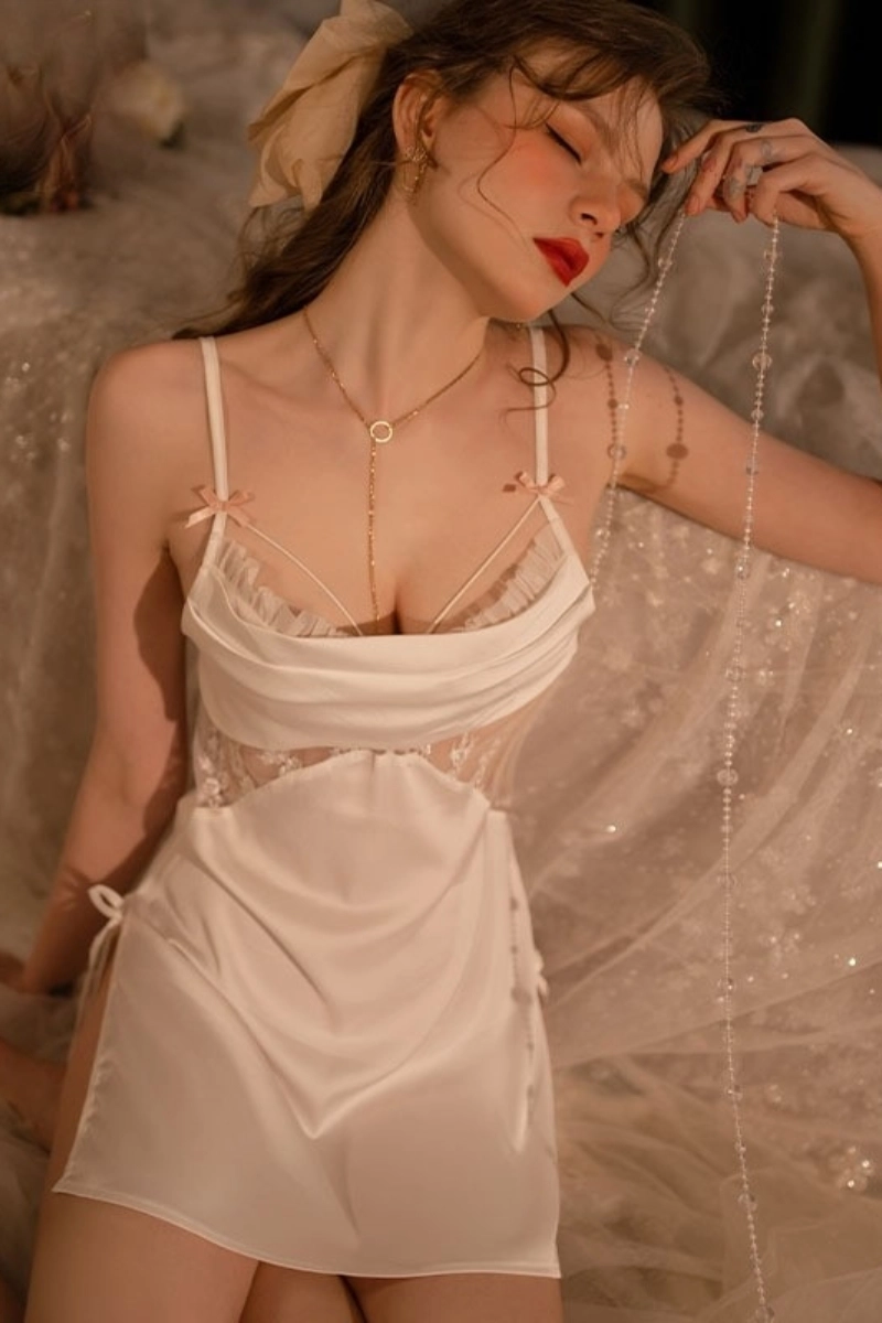 Alt：Model wearing white wholesale lace cuffs pajamas in soft lighting