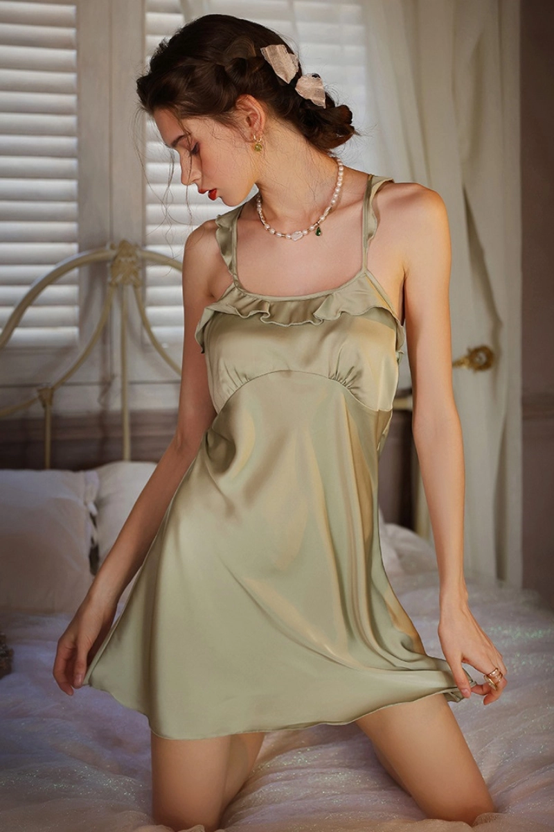 Model wearing custom bridal lace pajama set in light olive green with ruffle neckline