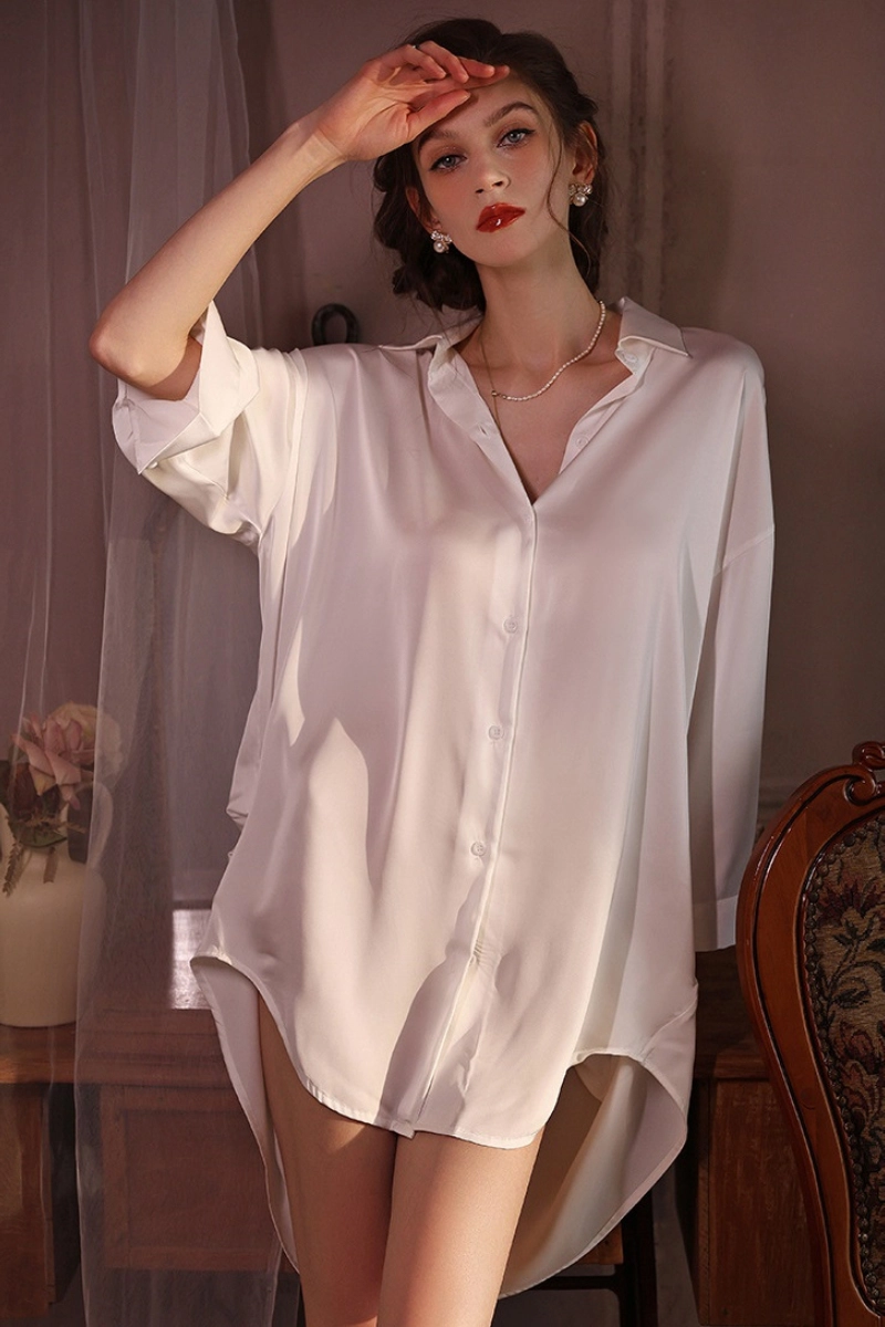 Model wearing white cosabella lace pajamas in relaxed bedroom setting