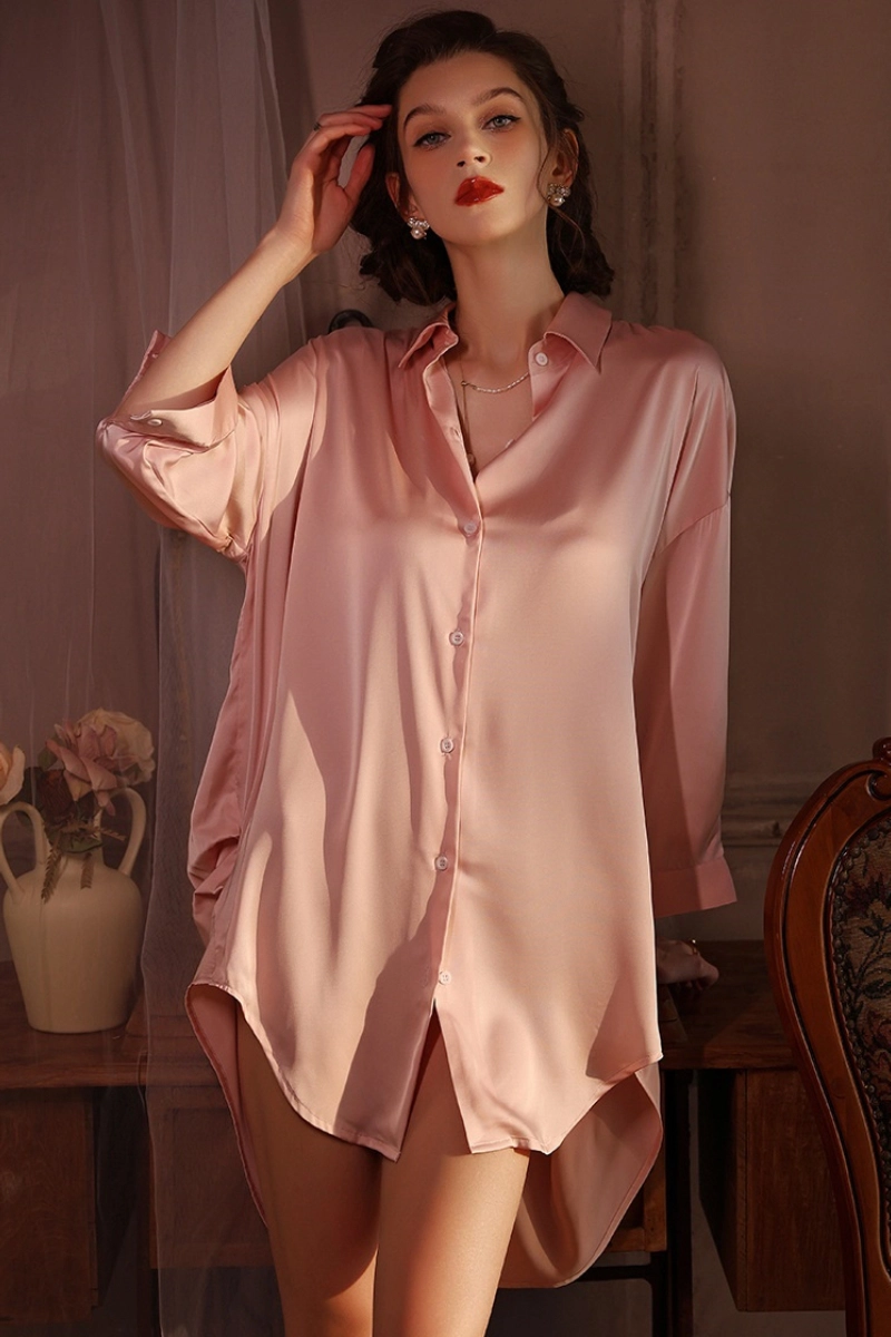 Model in rose pink cosabella lace pajamas posing by the curtain