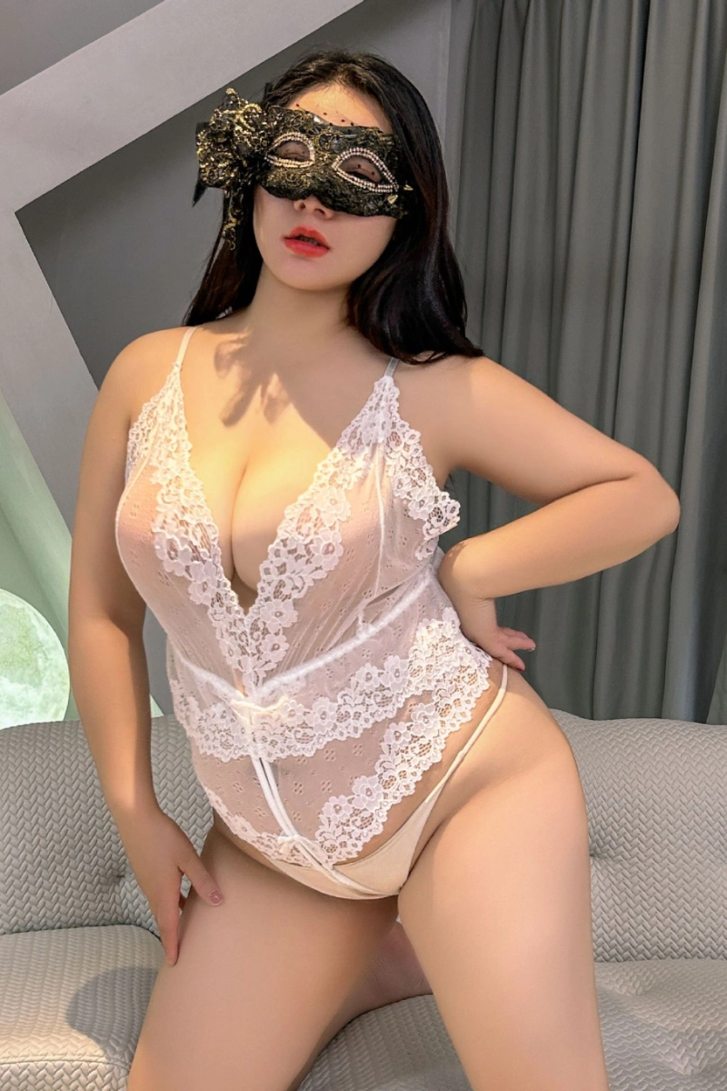 Woman wearing white transparent lace pajamas with floral trim