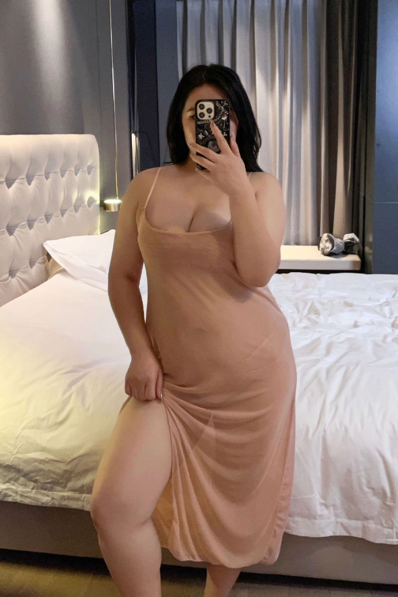 Alt text:Curvy model wearing thin lace Pajamas in nude color with minimal straps
