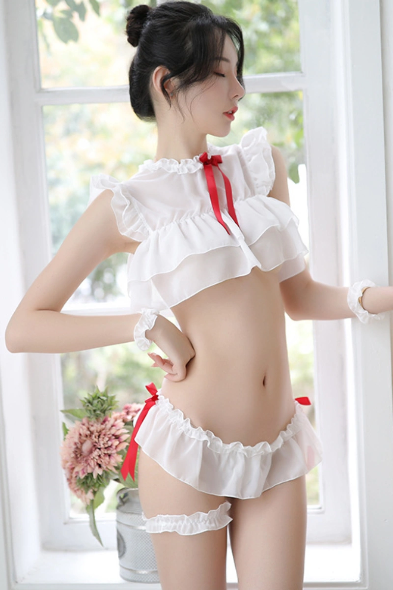 Model in b2b erotic student costume featuring a white ruffle bra top with red bow and matching panties