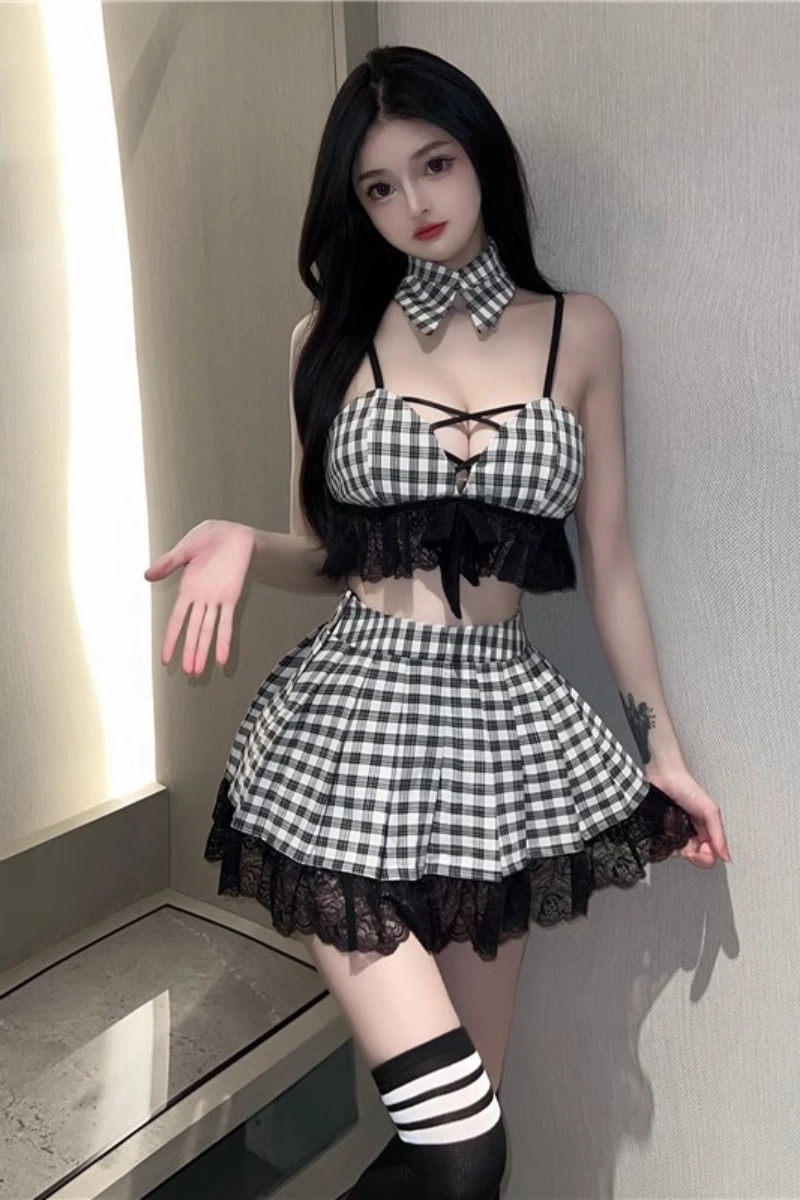 Model wearing a wholesale lace student costume featuring a black and white plaid crop top, lace trim, and pleated skirt.