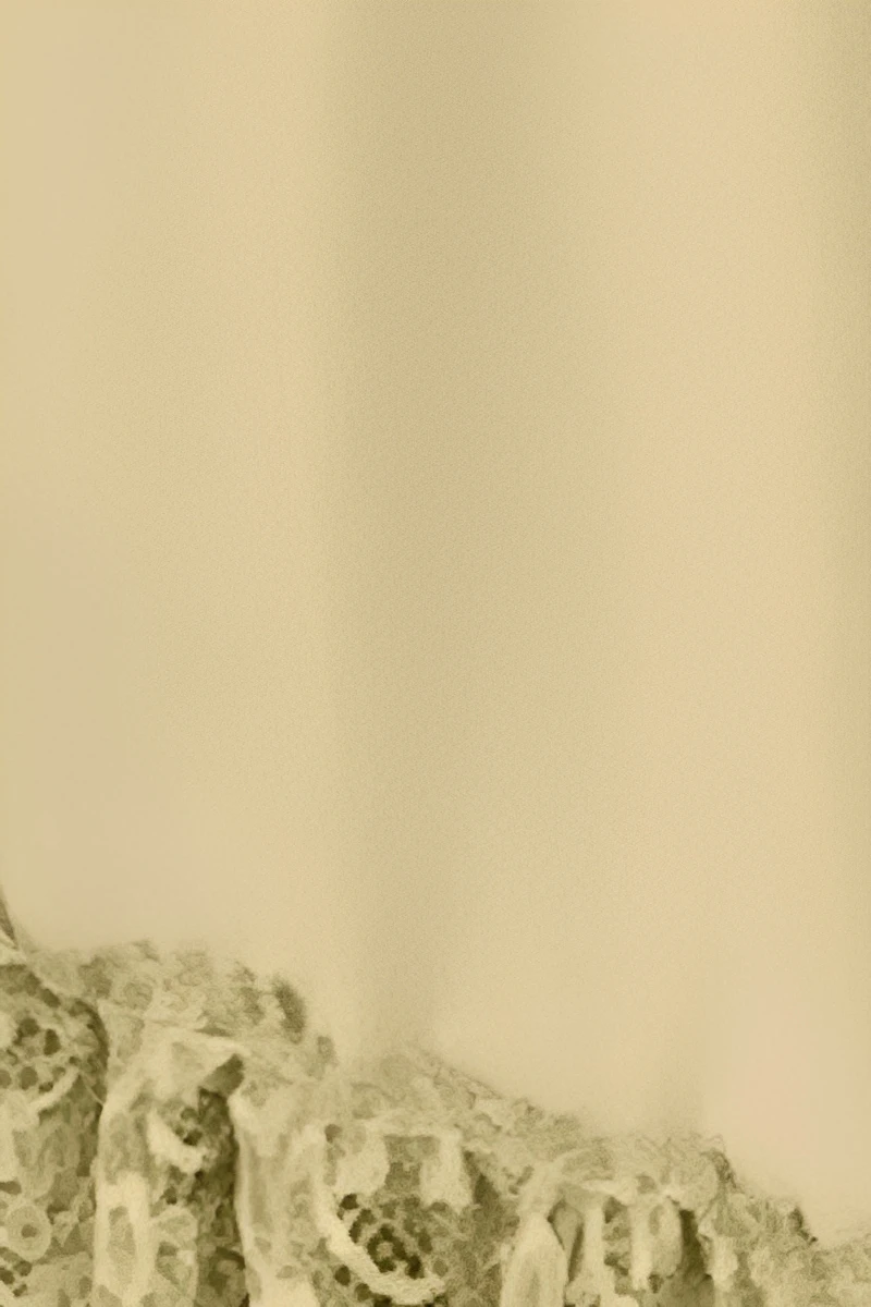 Close-up view of b2b Pajamas lace fabric showing fine lace texture and stitching quality.