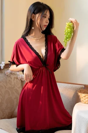 Model wearing a red wholesale silk satin lace pajama set featuring a deep-V neckline and black lace trim for elegant bedroom style.