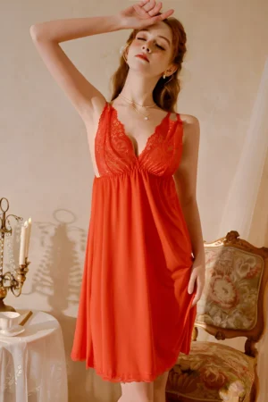 Model wearing a red b2b silk lace pajama set with lace bust detail and flowing sleeveless design