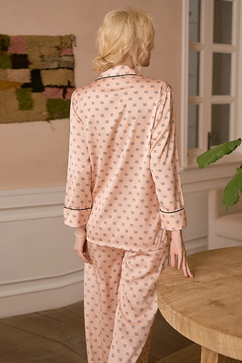 Back view of model wearing a b2b women's light pink sexy nightgown pajama set with long sleeves, soft fabric, and relaxed fit designed for nightwear collections.