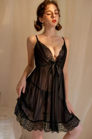 Model wearing black sheer lace pajamas women featuring a deep V neckline, soft lace trim, and lightweight transparent fabric.