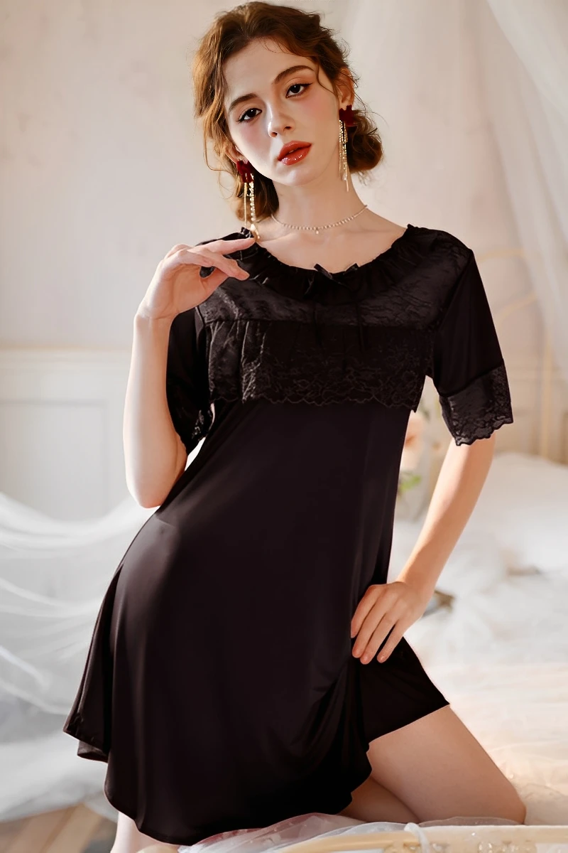 Model posing in a black bulk cotton lace pajama set with lace chest panel and short sleeves for women’s nightwear wholesale