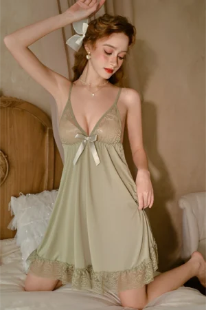 Model wearing a sage green lace babydoll nightdress with bow detail, showcasing a bulk cute lace pajama set for wholesale buyers