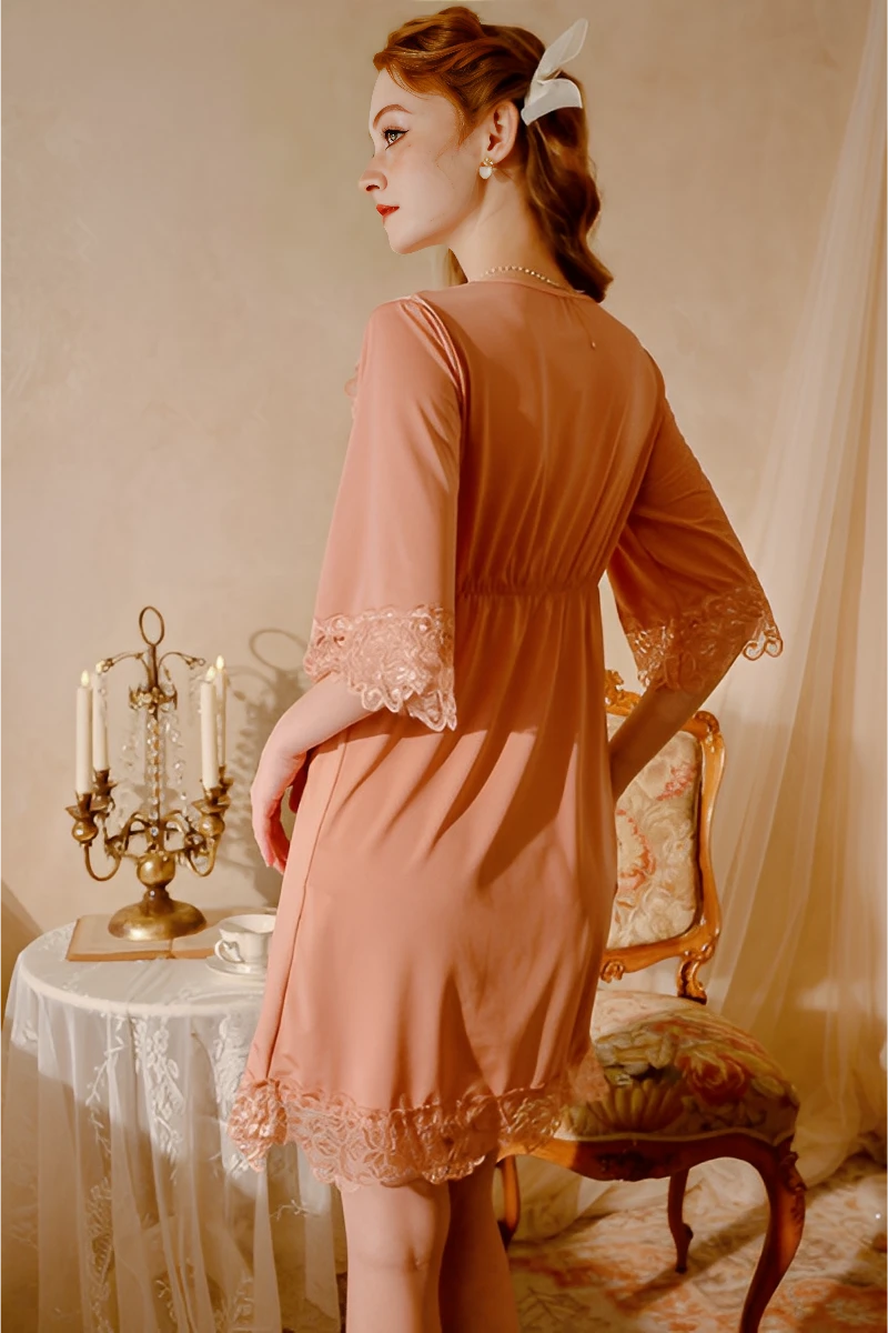 Back view of a peach bulk lace pajama showing smooth fabric drape, lace sleeve cuffs, and relaxed fit for women