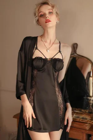 Model wearing a black bulk sexy silk nightgown featuring sheer lace side panels, slim straps, and a smooth silk finish for women’s nightwear collections.