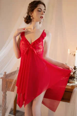 Model wearing a red bulk silk lace pajama set featuring sheer fabric, lace bodice, and lightweight flowing design for sexy nightwear collections.