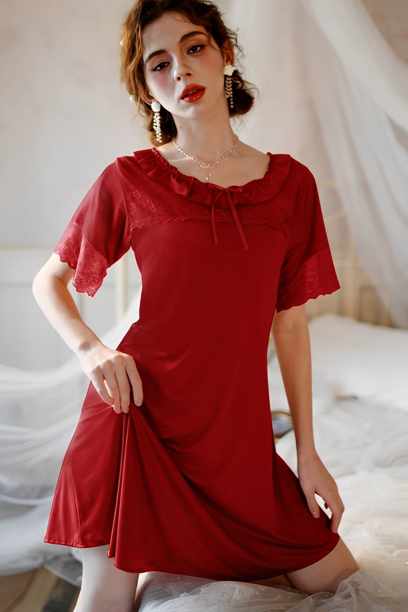 Model wearing bulk women's sexy solid color lace pajamas in deep red with lace trim and relaxed fit.