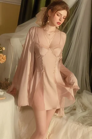 Model wearing a soft pink lace-trim nightgown with a sheer robe, showing elegant details suitable for bulk lace sexy nightgowns collections