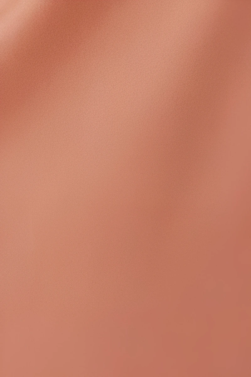 Model wearing custom lace bridal pajamas in soft pink featuring sheer lace bodice and flowing layered skirt