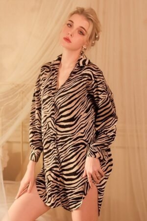 Model wearing a zebra print button-up sleep shirt styled as a custom sexy nightgown for women, loose fit with long sleeves for fashion nightwear.