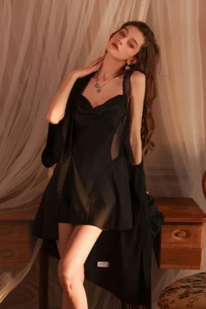 Model styled in custom women sexy nightgowns made from black silk, featuring a smooth bodice, flowing skirt, and matching robe.