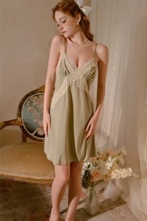 Model wearing a lace trim pajama set featuring a soft satin nightdress with delicate lace crossover design and adjustable straps