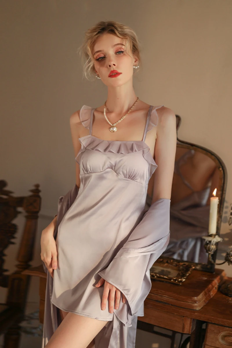 Model wearing a lavender satin slip nightdress with ruffle trim and matching robe, presented as a wholesale sexy chic nightgown