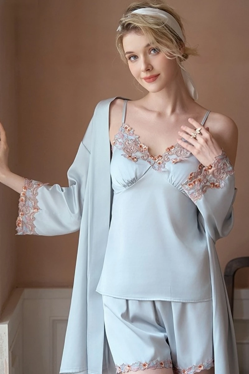 Light blue lace-trimmed camisole and shorts nightwear set with a flowing robe, presented as an oem sexy nightgown women style for lingerie manufacturers.