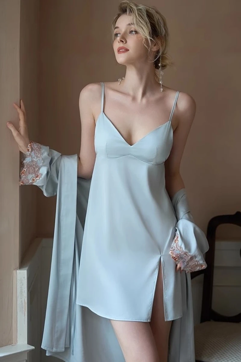 Model wearing a light blue satin slip nightgown with thin straps and a matching robe, featuring a side slit design for OEM sexy nightgowns collections.
