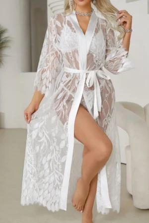 Model wearing an oem sexy white nightgown featuring sheer floral lace, a deep V neckline, and a self-tie waist in an elegant indoor setting.