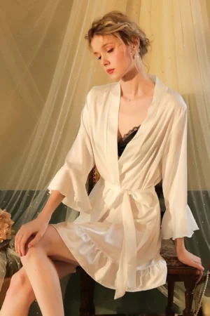 Model wearing white satin wrap robe with flared sleeves and ruffle hem, designed as oem sexy women nightgowns for women