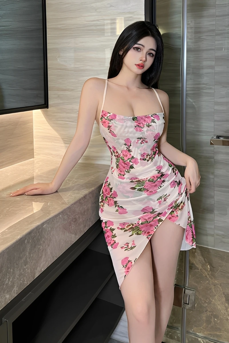 Model wearing a pink lace pajama set featuring a floral print slip dress with spaghetti straps and a high side slit, styled for elegant bedroom wear